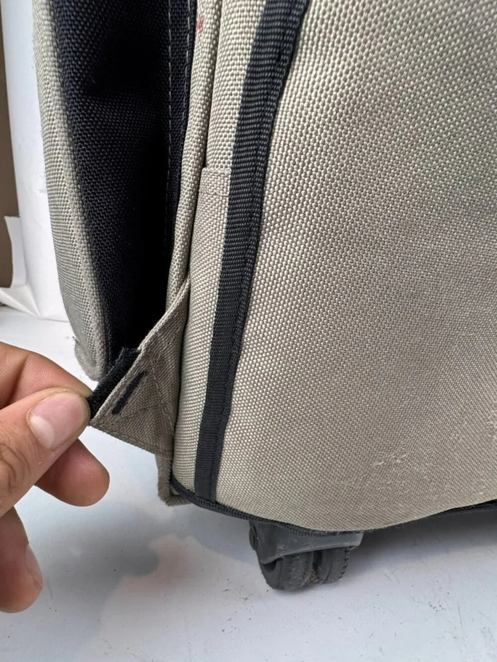 boy london rolling backpack tan wheeled suitcase travel bag tear fraying flaw